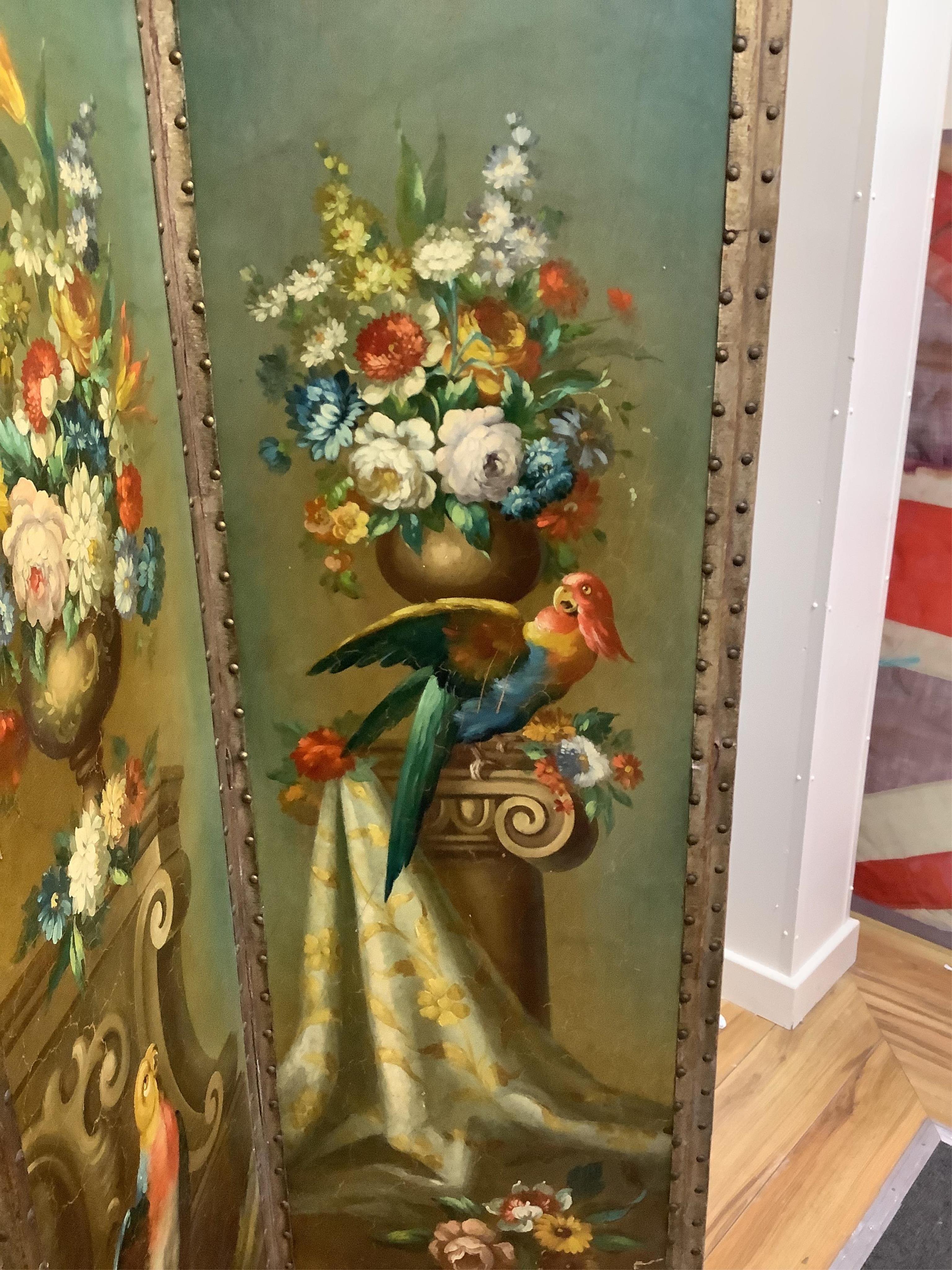 An early 20th century painted canvas three fold dressing screen decorated with parrots among vases of flowers, width 50cm, height 169cm. Condition - good